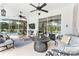 Spacious covered patio with multiple seating areas, a ceiling fan, and access to the beautiful backyard at 19115 Sw 98Th Loop, Dunnellon, FL 34432