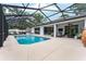 Backyard pool with a screened enclosure and a patio seating area, perfect for outdoor relaxation at 19115 Sw 98Th Loop, Dunnellon, FL 34432