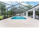 Sparkling pool within a screened enclosure, surrounded by a spacious patio and lush landscaping at 19115 Sw 98Th Loop, Dunnellon, FL 34432