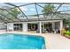 Stunning backyard pool with covered patio and ample lounging space, ideal for outdoor entertaining at 19115 Sw 98Th Loop, Dunnellon, FL 34432