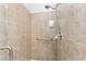 A shower with tiled walls, a grab bar, and modern shower fixtures at 19115 Sw 98Th Loop, Dunnellon, FL 34432