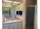 Bathroom vanity featuring a mirrored wall and a glass-enclosed shower at 19480 Sw 100Th Loop, Dunnellon, FL 34432