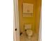 Cozy powder room featuring a tiled floor, toilet, and a cabinet for storage at 19480 Sw 100Th Loop, Dunnellon, FL 34432