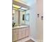 Bright bathroom with a large vanity, a well-lit mirror, and neutral decor at 19480 Sw 100Th Loop, Dunnellon, FL 34432