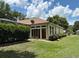Back exterior featuring a screened-in patio that offers an inviting indoor/outdoor living space at 19480 Sw 100Th Loop, Dunnellon, FL 34432