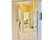 Hallway with views into multiple bedrooms featuring neutral paint, white doors, and tile flooring at 19480 Sw 100Th Loop, Dunnellon, FL 34432