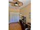 Comfortable office space with parquet floors, ceiling fan, and closet for storage at 19480 Sw 100Th Loop, Dunnellon, FL 34432