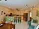 Combined kitchen and dining area features barstools, stainless appliances, light cabinetry, seating and plenty of light at 19480 Sw 100Th Loop, Dunnellon, FL 34432