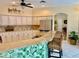 Kitchen features an island with barstool seating, light cabinetry and stainless steel appliances at 19480 Sw 100Th Loop, Dunnellon, FL 34432