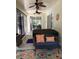 Inviting lanai with ceiling fans and comfortable seating near sliding glass doors to the backyard at 19480 Sw 100Th Loop, Dunnellon, FL 34432