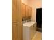 Spacious laundry room featuring a washer, dryer, and built-in wood cabinets at 19480 Sw 100Th Loop, Dunnellon, FL 34432