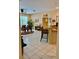 Open-concept home with tile flooring and a breakfast bar overlooking the dining area at 19480 Sw 100Th Loop, Dunnellon, FL 34432