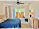 Spacious main bedroom with a door to the outside, neutral decor, and a king-sized bed at 19480 Sw 100Th Loop, Dunnellon, FL 34432