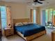 Cozy main bedroom with natural light, neutral decor, and a comfortable king-sized bed at 19480 Sw 100Th Loop, Dunnellon, FL 34432