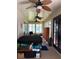 Relaxing sunroom featuring a hot tub, comfortable seating, and ceiling fans at 19480 Sw 100Th Loop, Dunnellon, FL 34432