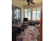 Bright and airy sunroom with comfortable seating, natural light, and a decorative rug at 19480 Sw 100Th Loop, Dunnellon, FL 34432