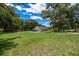 Expansive, well-maintained backyard featuring a home with a detached carport at 26 Count Fleet Dr, Ocala, FL 34482