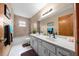 Full bathroom with double sink vanity, shower, and towel rack at 26 Count Fleet Dr, Ocala, FL 34482