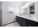 Bright bathroom features double sinks, large mirror, and modern fixtures at 26 Count Fleet Dr, Ocala, FL 34482