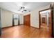 Bedroom with wood floors, ceiling fan, closet, and light-colored walls at 26 Count Fleet Dr, Ocala, FL 34482