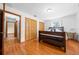 Bedroom features a dark wood bed frame, wood floors, and closet at 26 Count Fleet Dr, Ocala, FL 34482