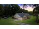 Lovely single-Gathering home with a lush green lawn, carport, and an attached two-car garage at 26 Count Fleet Dr, Ocala, FL 34482