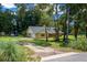 Sprawling single-story home with a carport and well-manicured lawn at 26 Count Fleet Dr, Ocala, FL 34482