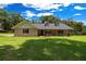 Inviting single-story home featuring a covered porch and lush green lawn at 26 Count Fleet Dr, Ocala, FL 34482