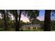 Charming single-story home featuring a well-manicured lawn and beautiful trees enhancing its curb appeal at 26 Count Fleet Dr, Ocala, FL 34482