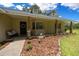 Inviting front porch with stone accents and lush landscaping at 26 Count Fleet Dr, Ocala, FL 34482