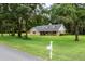 Charming single-story home with dormer windows, nestled among mature trees at 26 Count Fleet Dr, Ocala, FL 34482