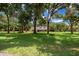Charming single-story home with a sprawling front lawn shaded by mature trees at 26 Count Fleet Dr, Ocala, FL 34482