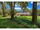 Single-story home with dormers surrounded by mature trees and lush greenery at 26 Count Fleet Dr, Ocala, FL 34482
