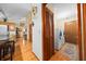 Hallway featuring hardwood floors and view of laundry room with modern front-loading washer and dryer at 26 Count Fleet Dr, Ocala, FL 34482