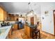 Well-lit kitchen featuring wood cabinets, granite countertops, stainless appliances, and center island with seating at 26 Count Fleet Dr, Ocala, FL 34482