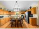 Spacious kitchen featuring wood cabinets, granite counters, stainless appliances, and large center island with seating at 26 Count Fleet Dr, Ocala, FL 34482