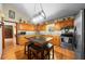 Updated kitchen featuring wood cabinetry, granite countertops, stainless appliances, and center island with seating at 26 Count Fleet Dr, Ocala, FL 34482