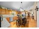 Spacious kitchen featuring wood cabinets, granite counters, stainless appliances, and large center island with seating at 26 Count Fleet Dr, Ocala, FL 34482