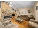 Inviting living room with hardwood floors, brick fireplace, and comfortable seating at 26 Count Fleet Dr, Ocala, FL 34482