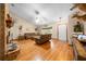 Open-concept living room with hardwood floors, brick fireplace, and natural light at 26 Count Fleet Dr, Ocala, FL 34482