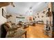 Spacious living room with hardwood floors, brick fireplace, and ample seating at 26 Count Fleet Dr, Ocala, FL 34482