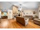 Spacious living room featuring hardwood floors and a cozy brick fireplace at 26 Count Fleet Dr, Ocala, FL 34482