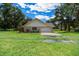 Well-maintained single-story home featuring an attached garage and lush yard at 26 Count Fleet Dr, Ocala, FL 34482