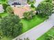 The home shows mature landscaping surrounding this pristine property at 2721 Day Lily Run, The Villages, FL 32162