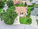 An aerial shot of the property features a welcoming entrance and mature landscaping at 2721 Day Lily Run, The Villages, FL 32162