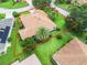 A bird's-eye view shows the well-manicured lawn and mature landscaping at 2721 Day Lily Run, The Villages, FL 32162