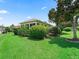 A lovely backyard with mature landscaping and lush green grass at 2721 Day Lily Run, The Villages, FL 32162