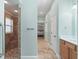 Hallway bathroom with stone shower and modern fixtures at 2721 Day Lily Run, The Villages, FL 32162