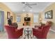 Inviting living room with wood floors, comfortable seating, and natural light at 2721 Day Lily Run, The Villages, FL 32162