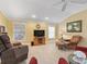 Inviting living room featuring comfortable seating, a vaulted ceiling, neutral paint, and ample natural light at 2721 Day Lily Run, The Villages, FL 32162
